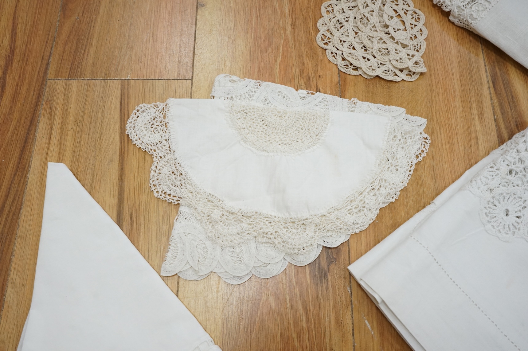 A collection of early 20th century and later crochet, cut work and drawn thread table linens and a large embroidered table cloth